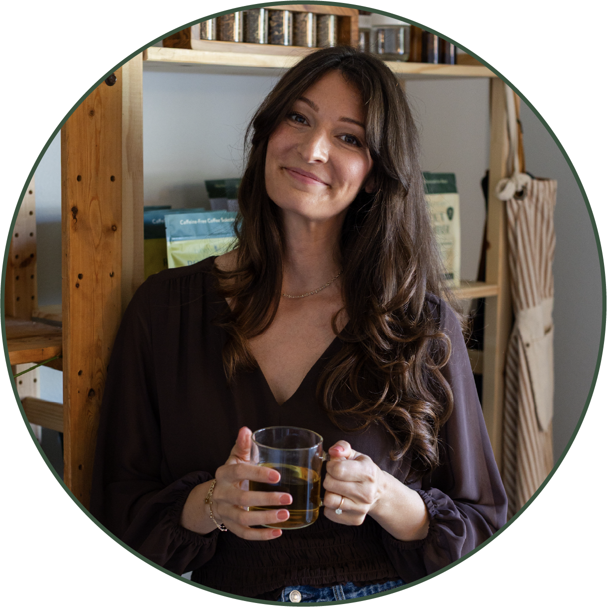 Rebecca, founder of Everyday Alchemy, holding a cup of tea