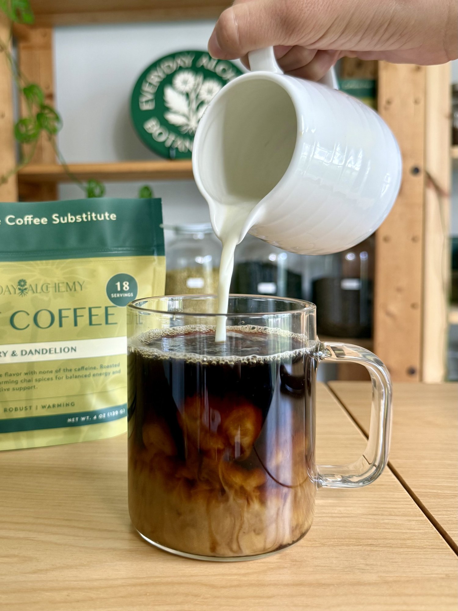Root Coffee latte in a glass mug